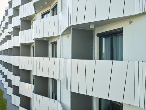 a facade of an apartment building with windows at Messe München Smartapart in Munich