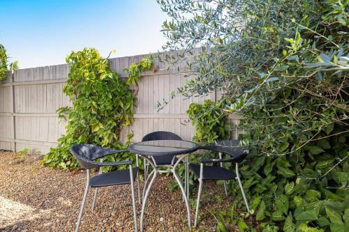 two chairs and a table in a garden at Scarborough Waterfront 2-bedroom Cottage in Scarborough