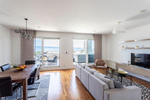 a living room with a couch and a table at Apartments Blue Maris Žnjan in Split