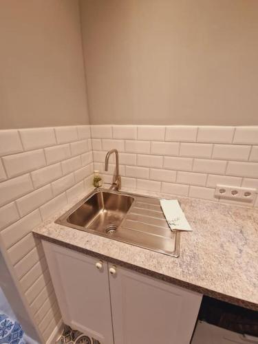 a kitchen counter with a sink in a room at Casa Lucia in Knittelfeld