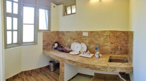 a kitchen with a stone counter and a sink at Hotel Yangbum in Gangtok