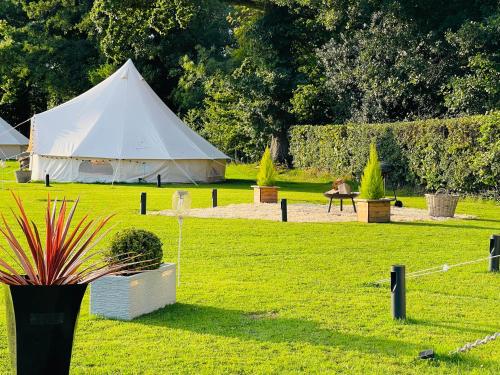 a white tent in the middle of a field at CAYORETREAT LUXURY BELL TENT in Clodock