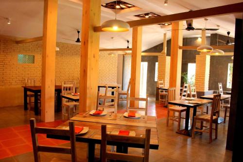 a restaurant with wooden tables and chairs and a dining room at Morning Star Resorts in Negombo