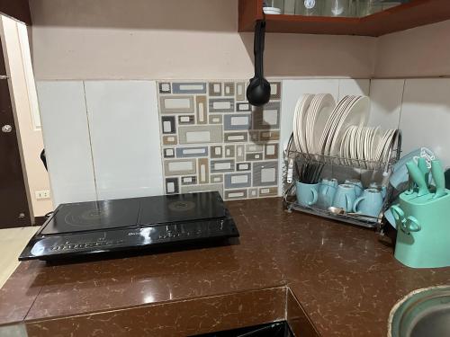 a kitchen with a counter top with a stove at Townes Huge Home Big Grps Big Fam Near SM Ecoland DGT Coastal road ADDU UM in Davao City