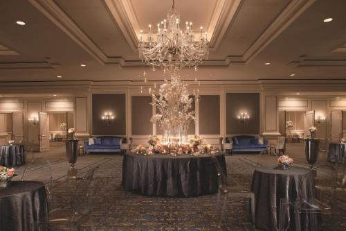 a banquet hall with a table with a chandelier at The Ritz-Carlton, St. Louis in Clayton