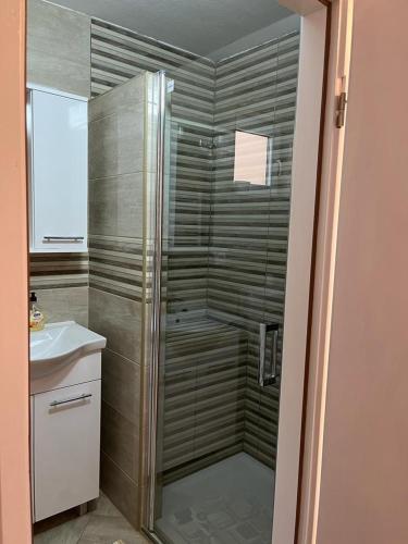 a bathroom with a shower and a sink at OPG - ZM APARTMANI MARTINOVIĆ in Novska
