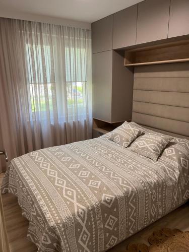 a bedroom with a large bed and a window at Apartament Akademicka in Białystok
