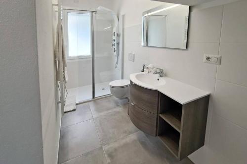 a bathroom with a sink and a toilet and a shower at Villa Bettina in Sarroch