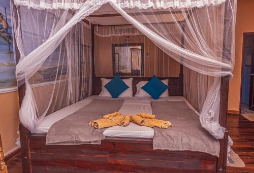 a bed with two teddy bears laying on it at Ravana Range Ella in Ella