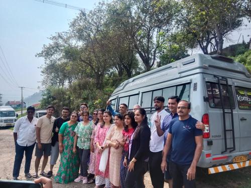 a group of people standing in front of a bus at Private 3BHK Villa with a Parking, Garden, WiFi, Mountain View in Kodaikānāl