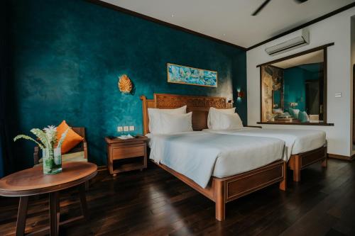 a bedroom with a large bed and a table at Amour Resort Bavi in Hanoi