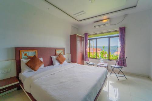 Postel nebo postele na pokoji v ubytování Veggies Residency