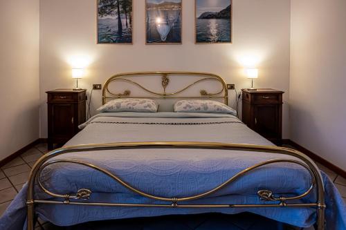 a bedroom with a bed with two lamps on the wall at Casa Emilia in Riva di Solto