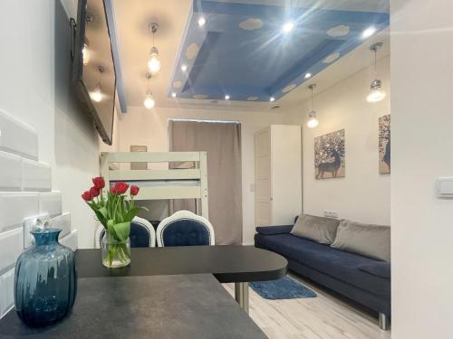 a living room with a blue couch and a table at Solne Apartamenty Luna in Wieliczka