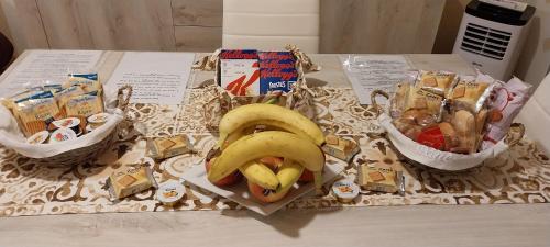 two bananas and some snacks on a table at Appartamento Beatrice in Villanova dʼAsti