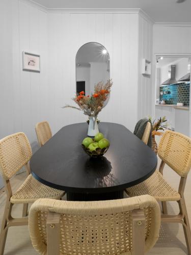 a black dining room table with a bowl of fruit on it at AZZURRO POD HOTEL - Central Sydney in Sydney