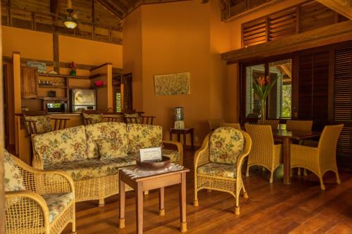 a living room with a couch and chairs and a table at Tropical Breeze in Palmetto Bay in Palmetto Bay