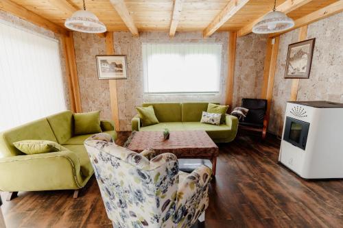 a living room with a couch and chairs and a table at VillaRostovo in Bugojno