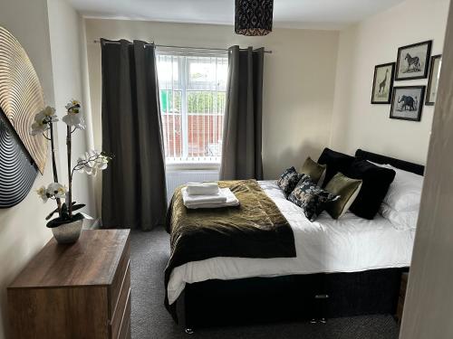 a bedroom with a large bed and a window at Safari Avenue one Bedroom Apartment in Stapleford