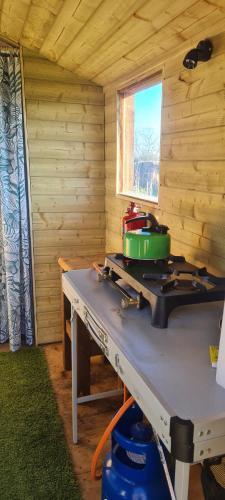 a stove with a pot on top of it in a room at Cherry Trees Farm Campsite in Welton