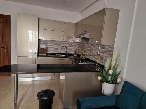 a kitchen with a black counter top in a room at Palm lake resort Folla Monastir in Monastir