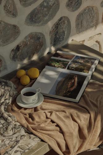 a table with a laptop and a cup of coffee at Zaira Hotel in Skála Loutrón