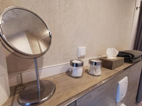 a mirror sitting on top of a counter in a bathroom at Apartment Maiglöckchen in Fritzlar