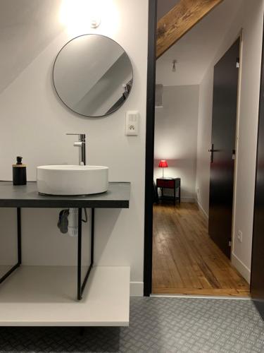 a bathroom with a sink and a mirror on the wall at Le 24’ Chrono in Le Mans