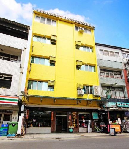 a yellow building on the side of a street at 日月潭 -日月住館 in Yuchi