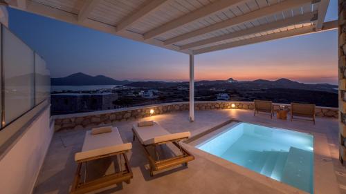 a villa with a swimming pool on a roof at Thea Sunset Suites in Mytakas