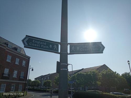 a pole with street signs on a street at Beautiful Marina Apartment with private garden, flexible bedrooms with zip & link beds in Gosport