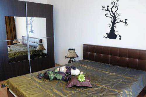 a bedroom with a large bed with a mirror at Sea Dream Rental Apartments in Varna City