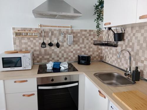 a kitchen with a sink and a microwave at Blue Ocean in Costa Teguise