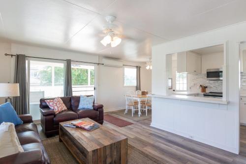 a living room with a couch and a table at Steps to the beach upstairs Apartment with 3 bedrooms & 2 bath AC in Kailua