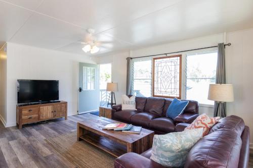 a living room with a couch and a tv at Steps to the beach upstairs Apartment with 3 bedrooms & 2 bath AC in Kailua