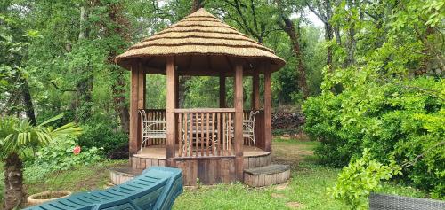 a gazebo with a bench in a garden at Villa Eden Vert in Fayence