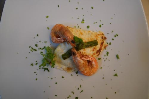 a white plate with a sandwich with shrimp on it at Hotel Albatros in Ischia