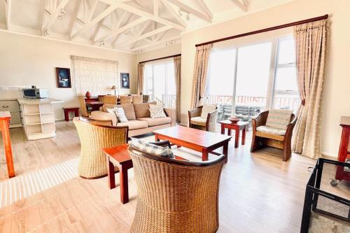 ein Wohnzimmer mit einem Sofa und einem Tisch in der Unterkunft Luxury Lodge at Pinnacle Point in Mossel Bay