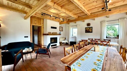 a living room with a large wooden table and chairs at Apartament w Bukowej Chacie in Mörken