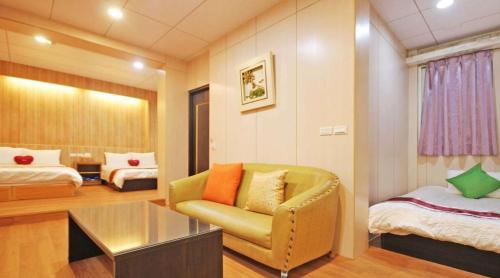 a room with a couch and a bed and a chair at 日月潭 -日月住館 in Yuchi