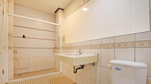 a bathroom with a sink and a toilet at 日月潭 -日月住館 in Yuchi