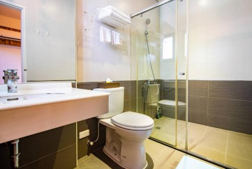 a bathroom with a toilet and a sink and a shower at Wind Breathing B&B in Toucheng