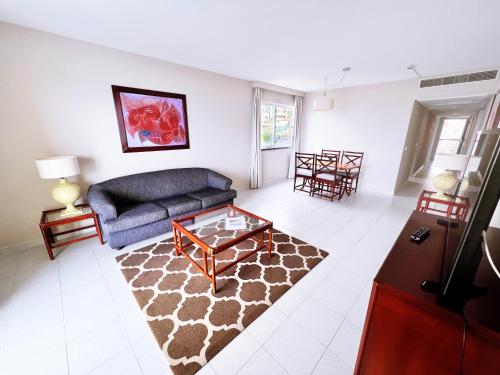 a living room with a couch and a coffee table at Atlantic Gardens Beach - atlanticgardensbeach com in Funchal