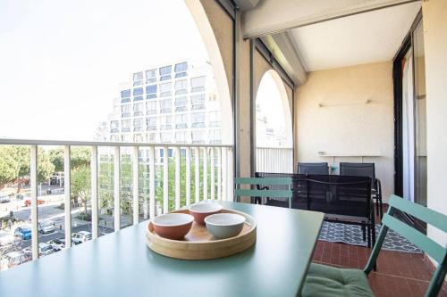 - une table avec des bols sur le balcon dans l'établissement Séjour de rêve à La Grande Motte T2 entièrement neuf, clim, wifi, parking privé, à La Grande Motte