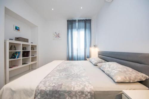 a bedroom with a large bed and a window at Apartment MIAMAR with port sea view in Dubrovnik