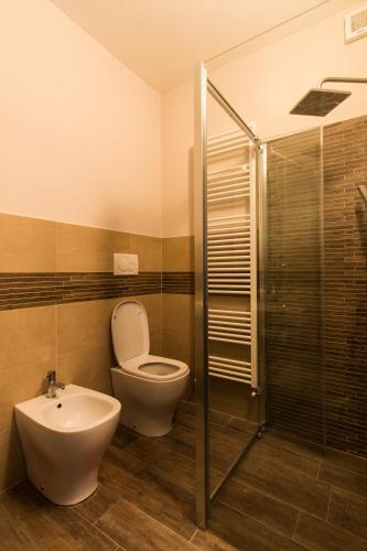 a bathroom with a toilet and a sink and a shower at Appartamenti Gli Ippocastani in San Benedetto Belbo