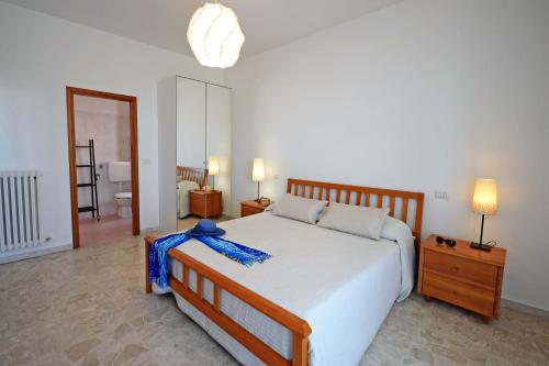 een slaapkamer met een bed met een blauw lint erop bij Appartamento Bellariva A1 - MyHo Casa in Porto San Giorgio