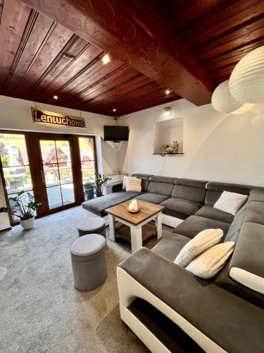 a living room with a couch and a table at Penzion Katarina in Ždiar