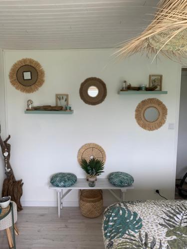 a bedroom with a table and two stools at Chambre d’hôtes coconing in Brélès