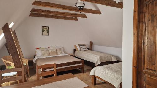 a room with two twin beds and a chair at Studio Rasnov Apartaments in Râşnov